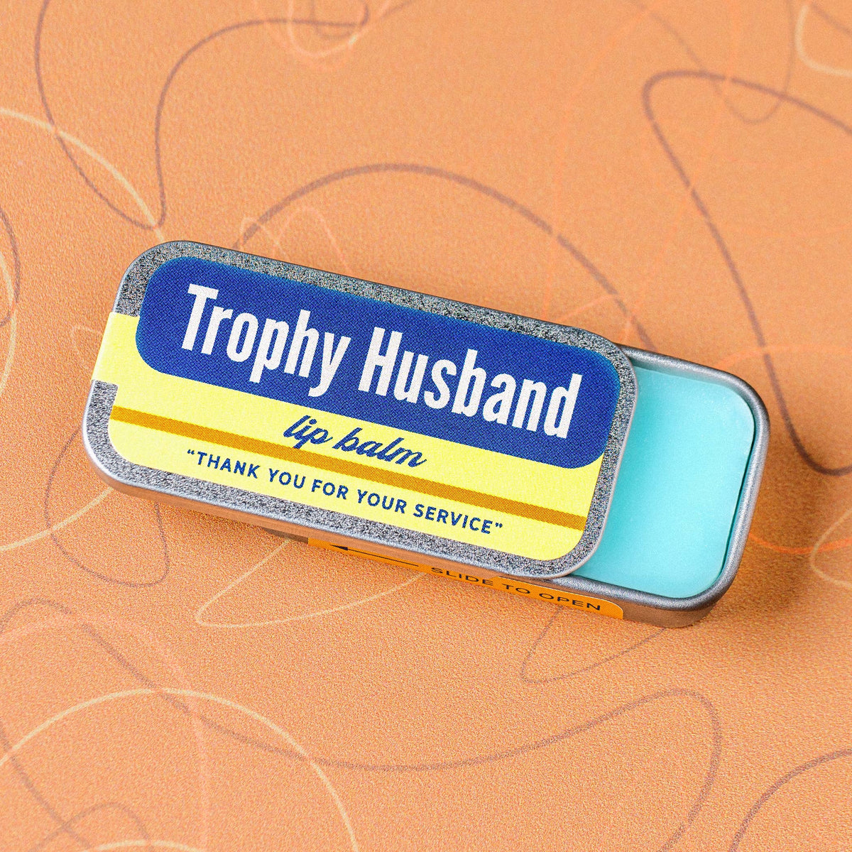 Trophy Husband blue raspberry lip balm in an old school metal tin by Whiskey River Soap Co., from The Ruddy Duck in Whitefish, Montana
