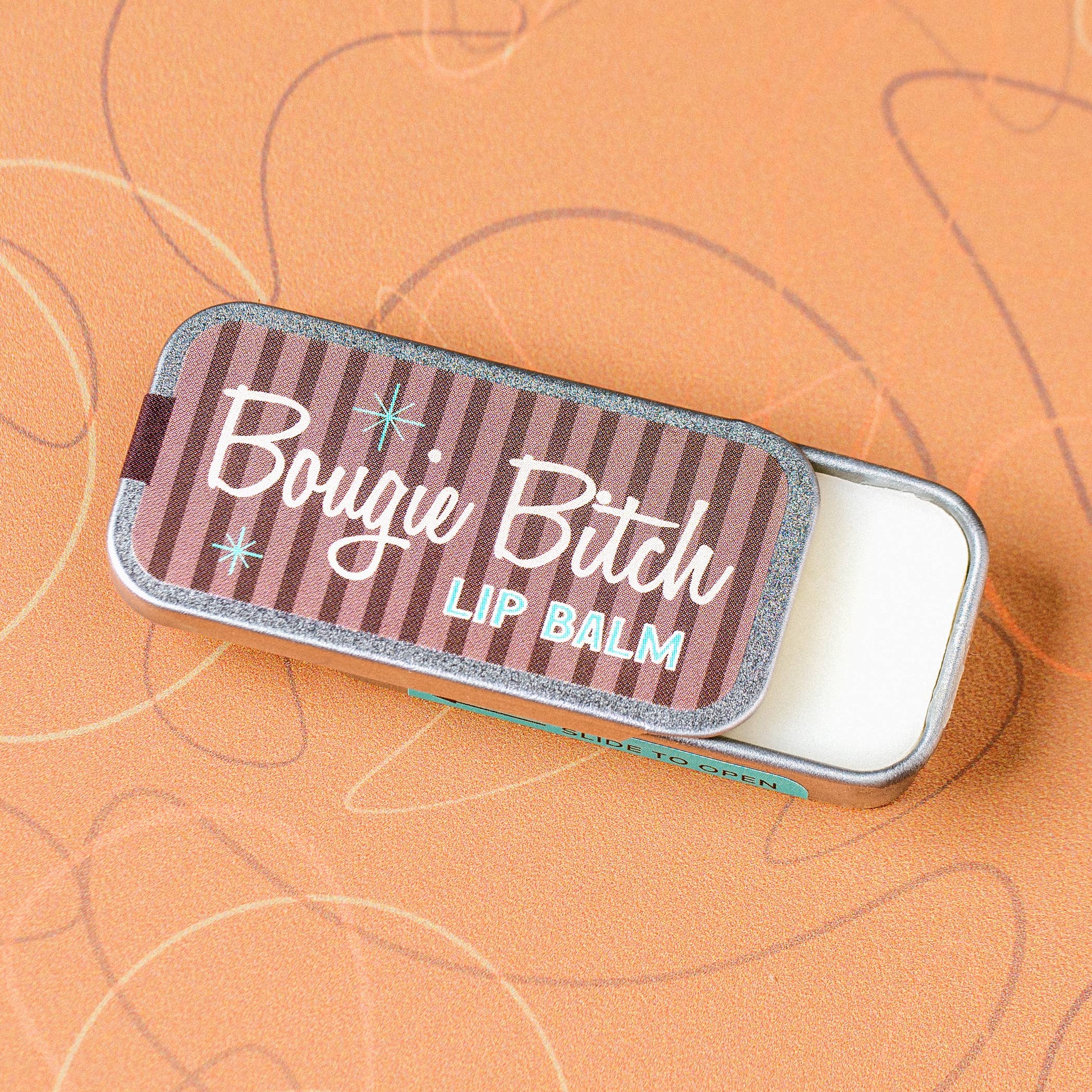 Bougie Bitch vanilla lip balm in an old school metal tin by Whiskey River Soap Co., from The Ruddy Duck in Whitefish, Montana