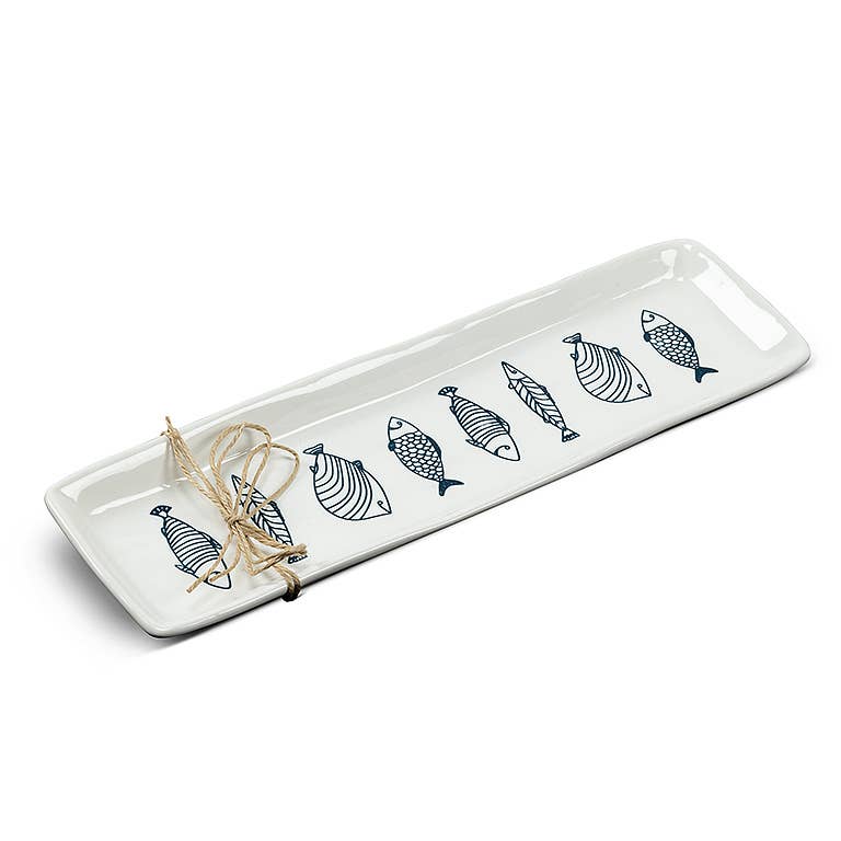 Long white stoneware serving plate with blue line-drawn fish, from The Ruddy Duck in Whitefish, Montana