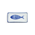 White porcelain sauce dish with blue fish design and blue trim, from The Ruddy Duck in Whitefish, Montana
