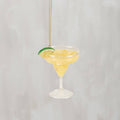 Glass margarita cocktail ornament with a lime wedge on the rim and a gold hanging cord, from The Ruddy Duck in Whitefish, Montana