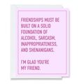 Card with humorous friendship quote on a pink background
