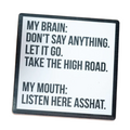 Coaster with humorous text on a wooden surface