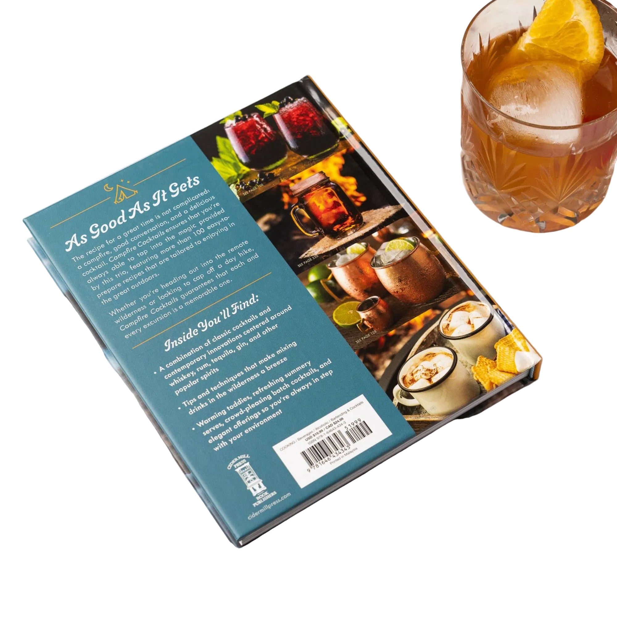 Cookbook with images of drinks on a marble table next to a cocktail.