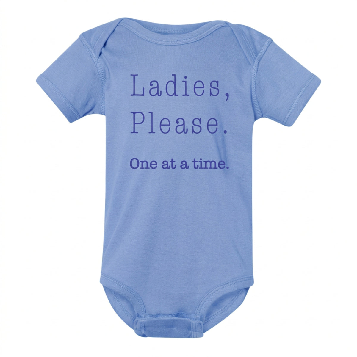 Blue baby onesie that says Ladies, Please. One at a Time in purple typewriter lettering, from The Ruddy Duck in Whitefish, Montana