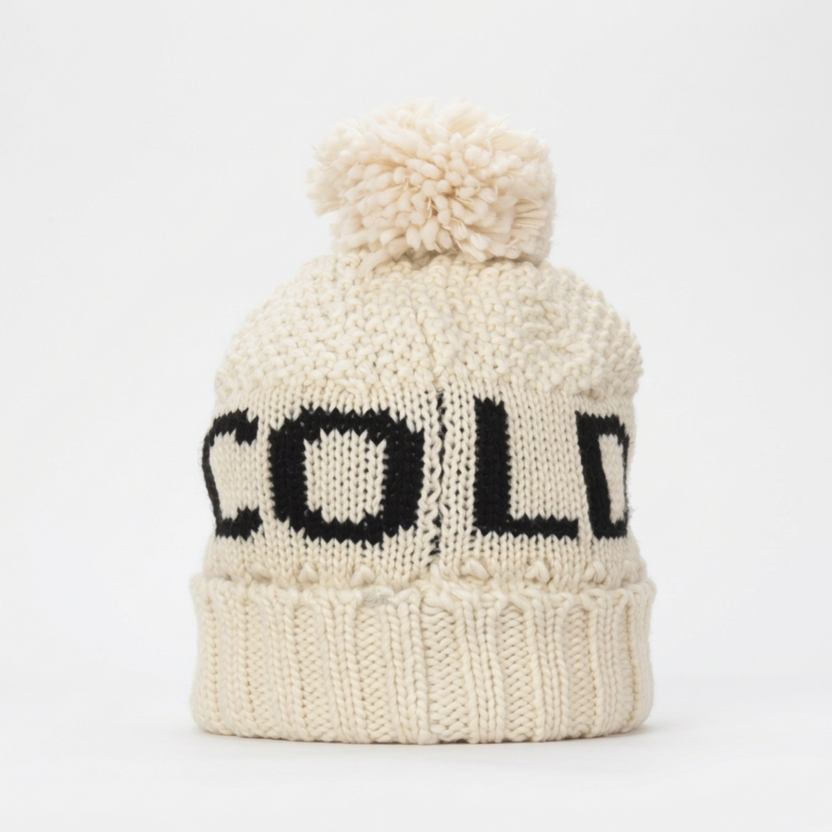 Cream knit pom beanie with a black Cold Alpine design, from The Ruddy Duck in Whitefish, Montana