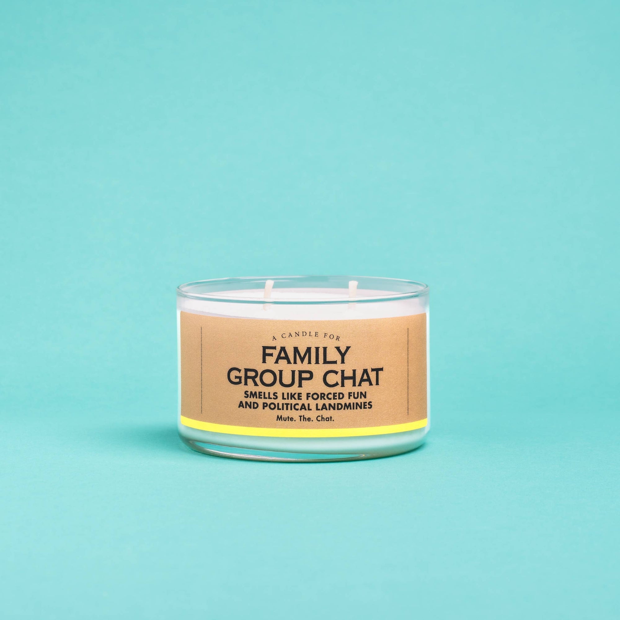 Candle with a humorous label on a teal background