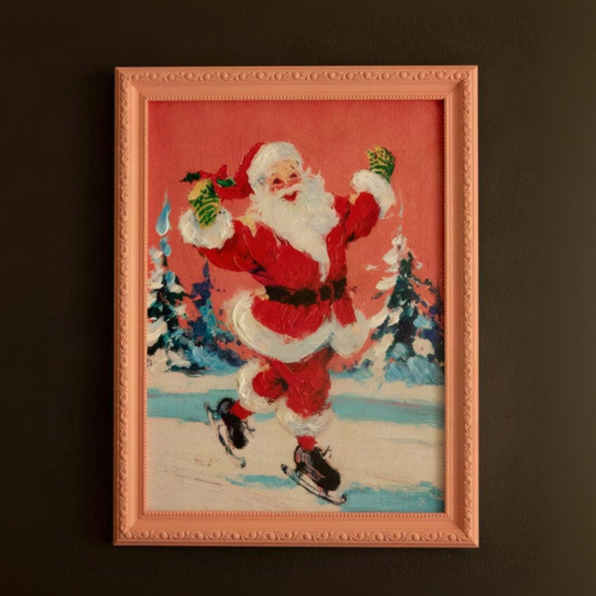 A framed vintage-style Christmas painting depicting Santa Claus skating in the snow against a red sky, mounted on a dark brown wall.