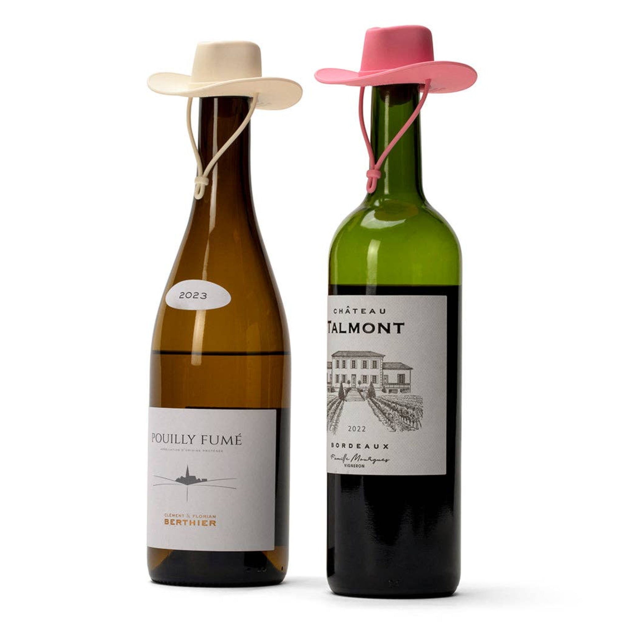 Two wine bottles on a white background, each wearing a small cowboy hat tied around the neck. The left bottle is amber glass with a cream hat and a white label reading 'Pouilly Fumé'; the right bottle is green glass with a pink hat and a darker label reading 'Château Althamont'.