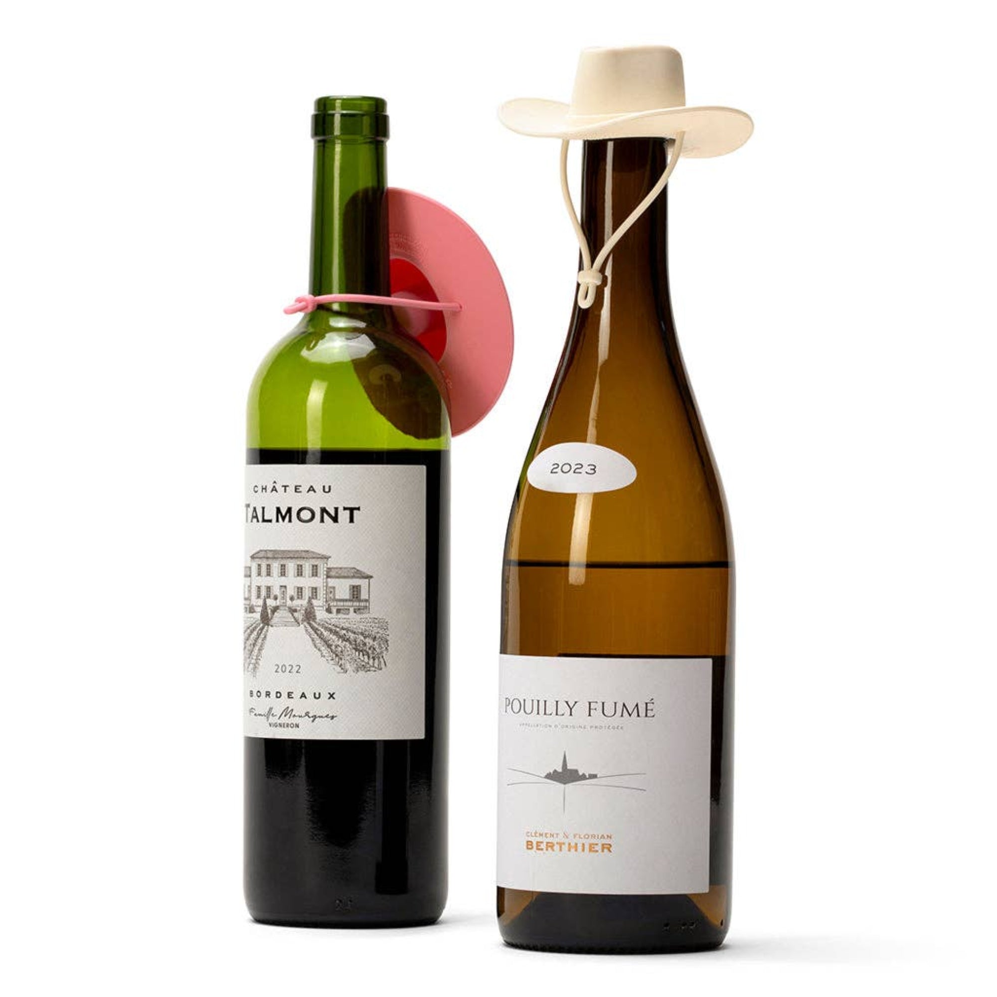 Two wine bottles on a white background: a dark green bottle labeled Château Almont 2022 and an amber bottle labeled Pouilly Fumé 2023, each with a small decorative hat and ribbon on the neck.