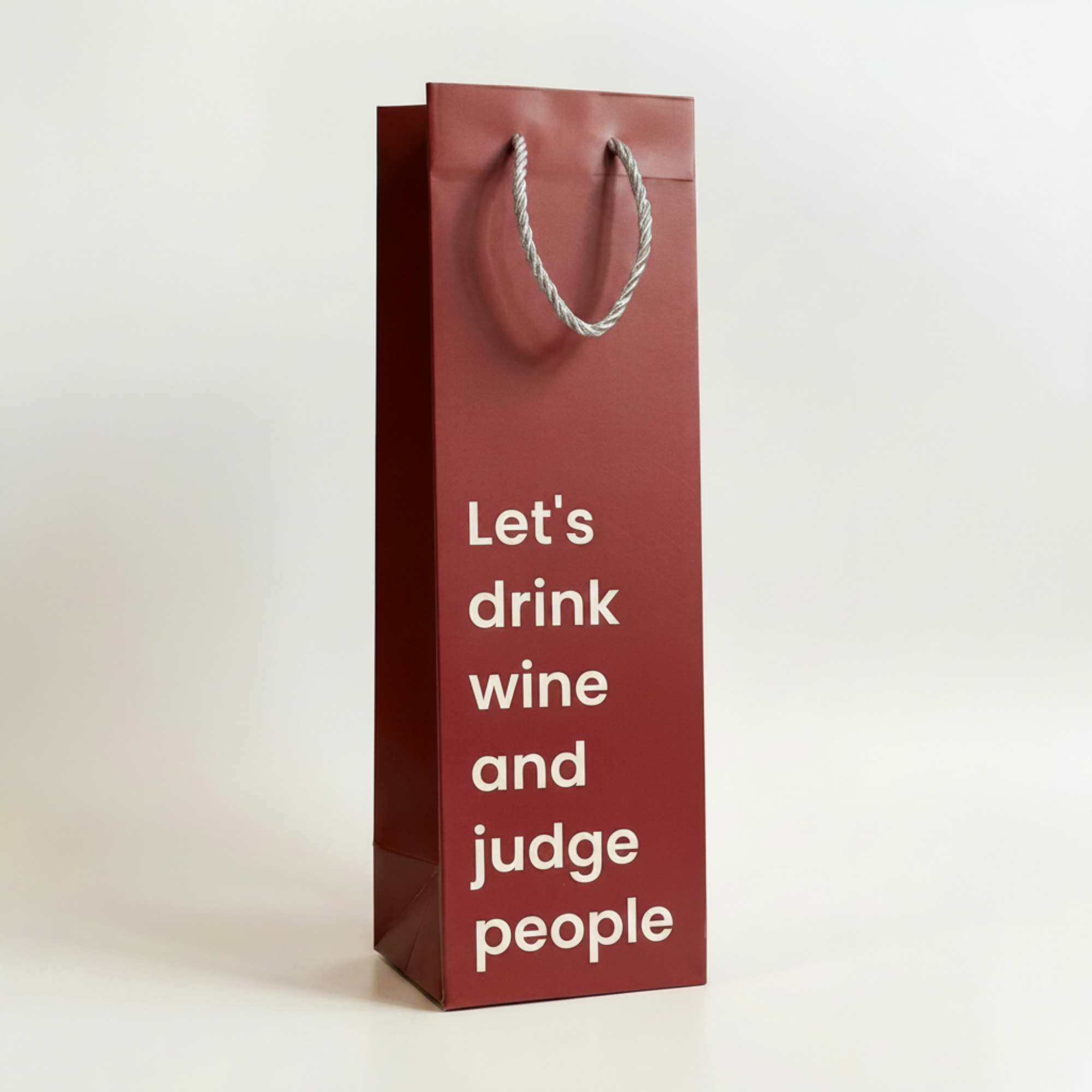 Red wine bag with white text on a light gray background