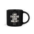 Black mug with white text on a white background