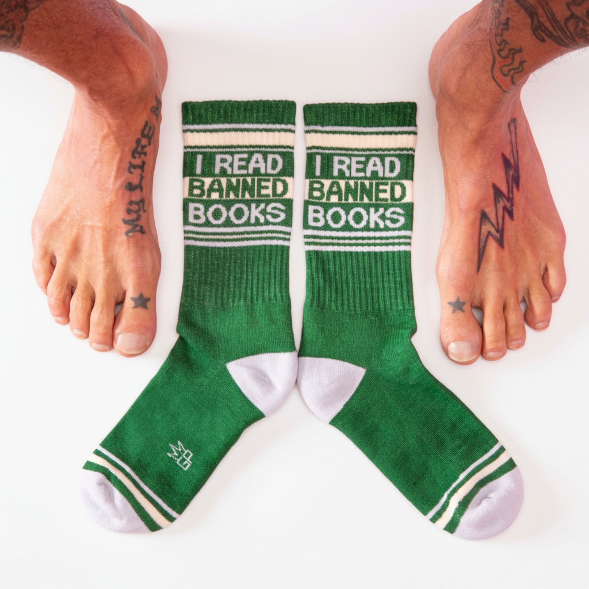 Green socks with 'I Read Banned Books' text on a pink background