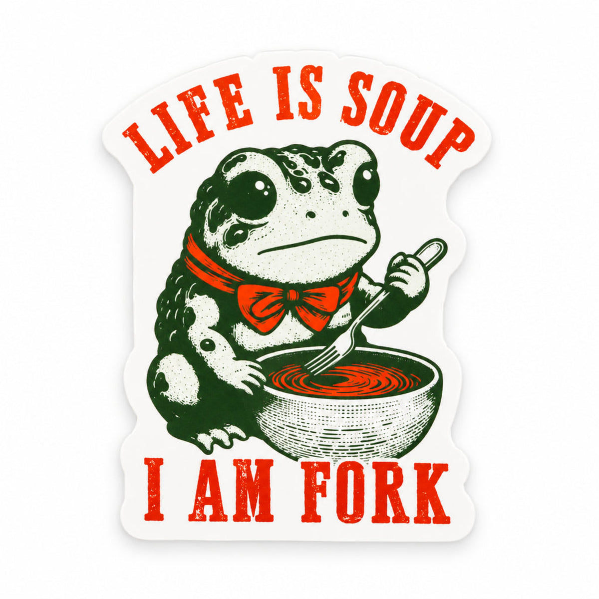 A die-cut sticker featuring a green and white cartoon toad wearing an orange bow tie and holding a spoon over a bowl of orange soup, with the text 'LIFE IS SOUP I AM FORK' in orange lettering, shown on a dark textured background.