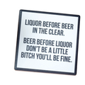 Coaster with humorous text on a wooden surface