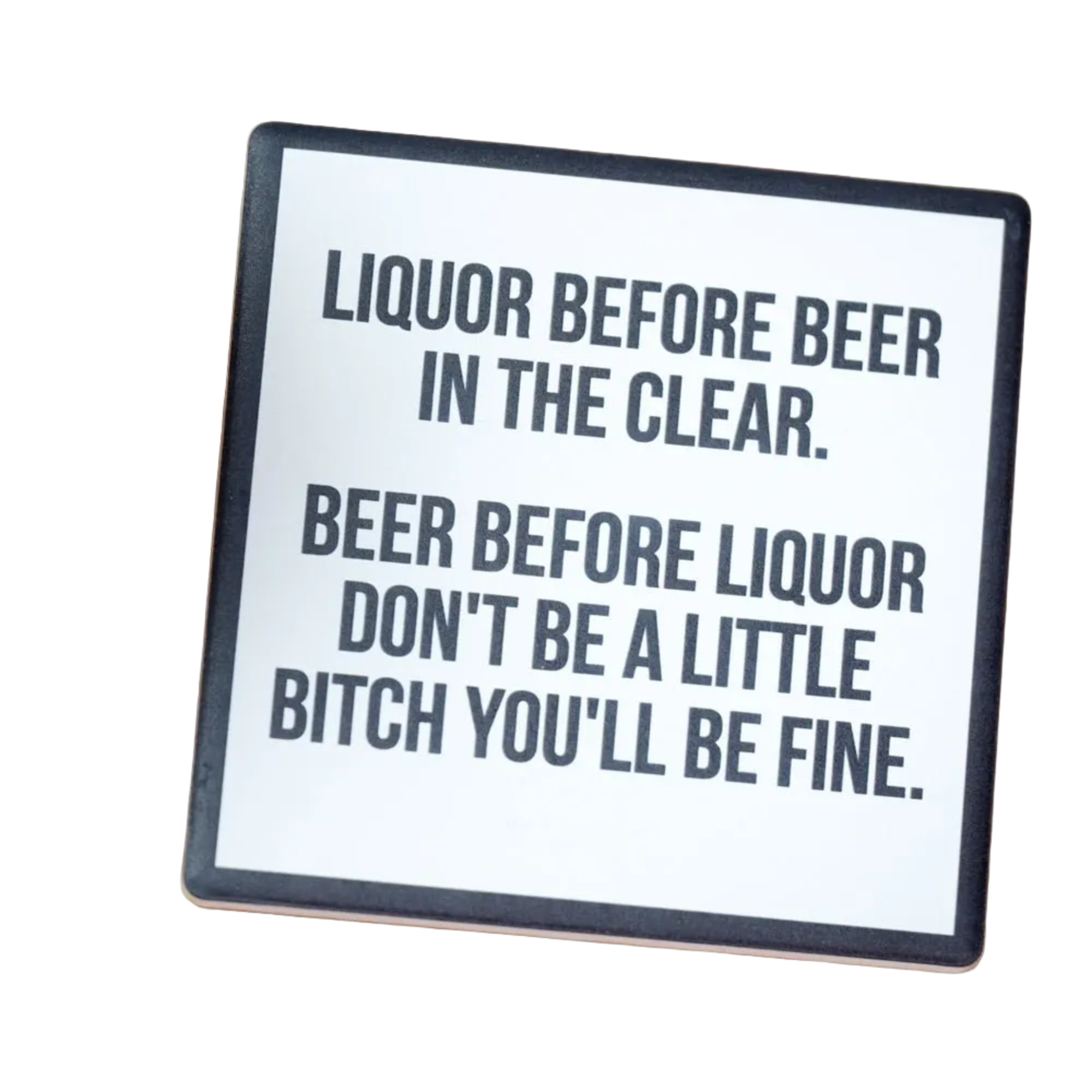 Coaster with humorous text on a wooden surface