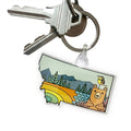 Keychain with a colorful design of a bear and nature elements on a white background