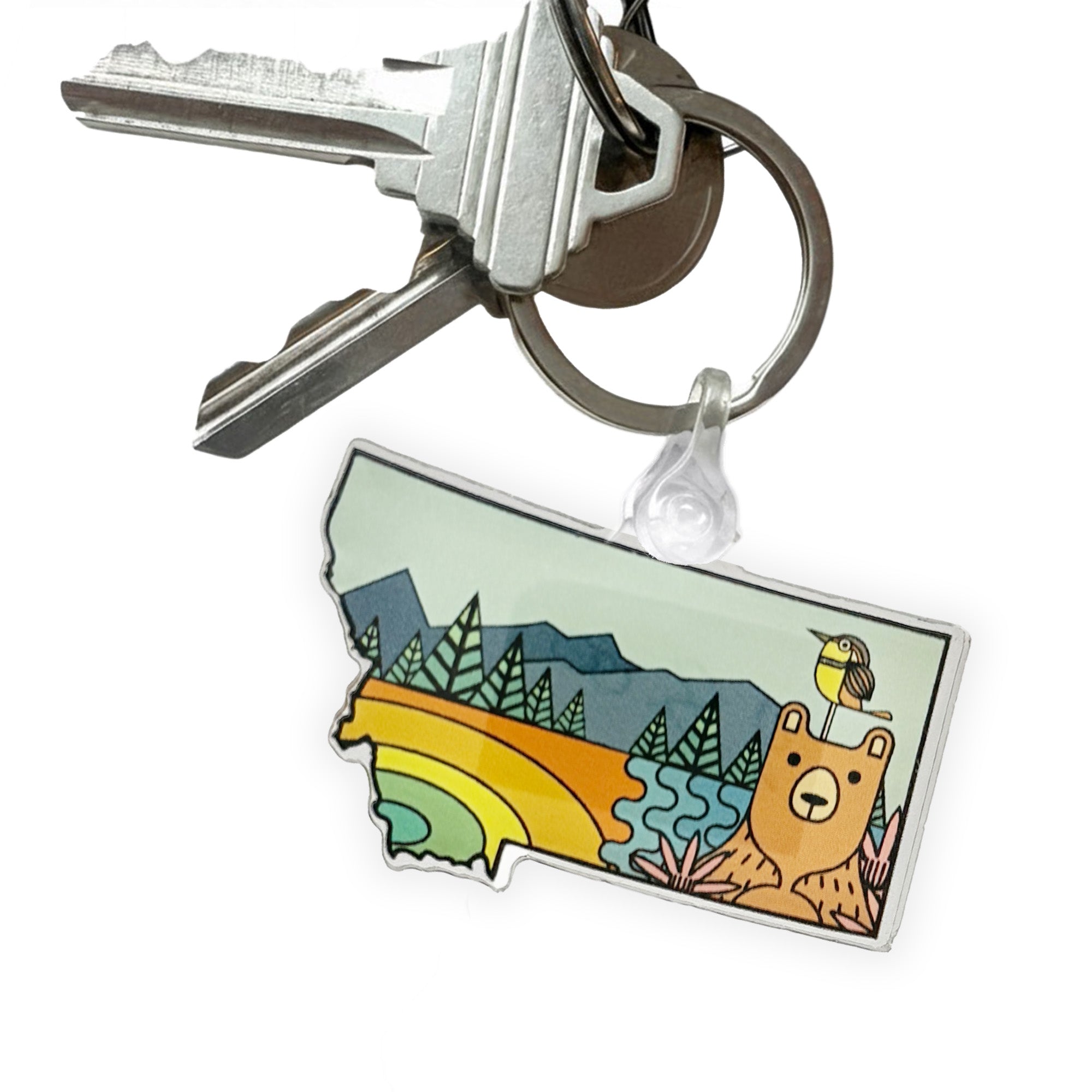 Keychain with a colorful design of a bear and nature elements on a white background