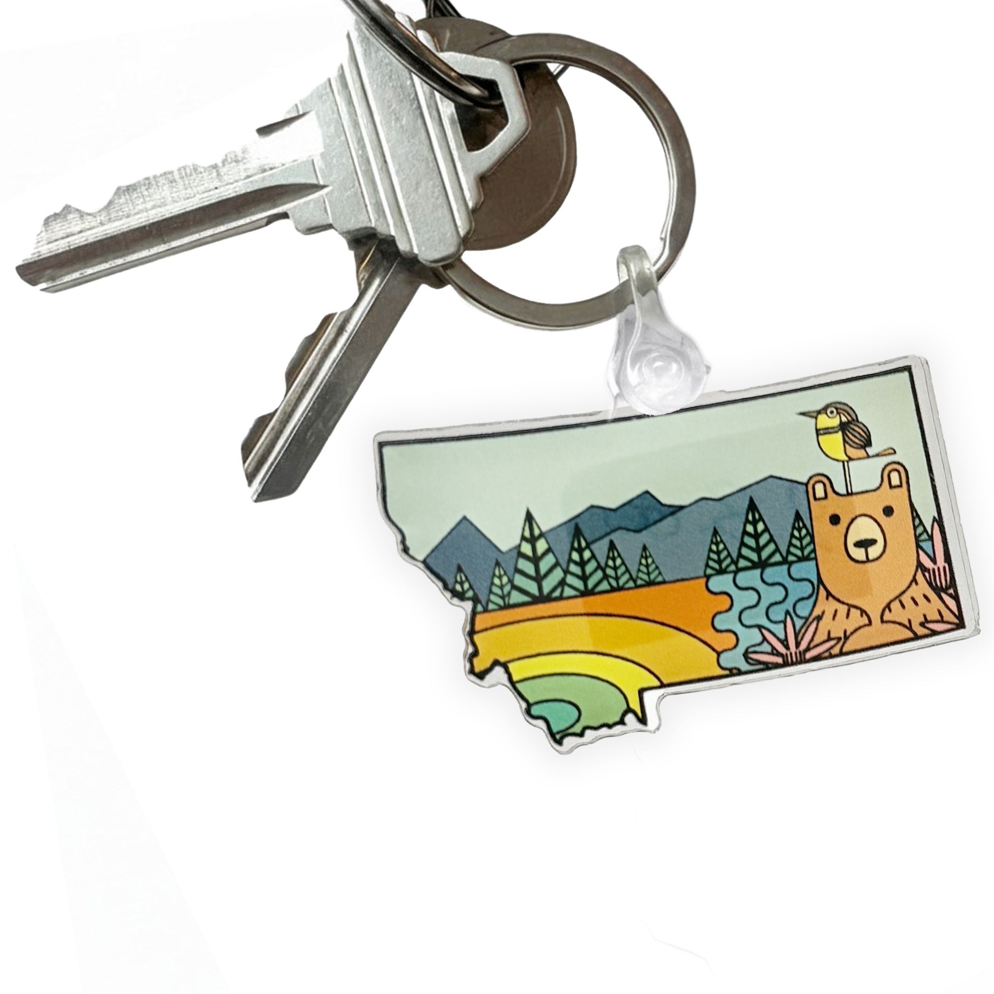 Keychain with a colorful design of a bear and nature elements on a white background