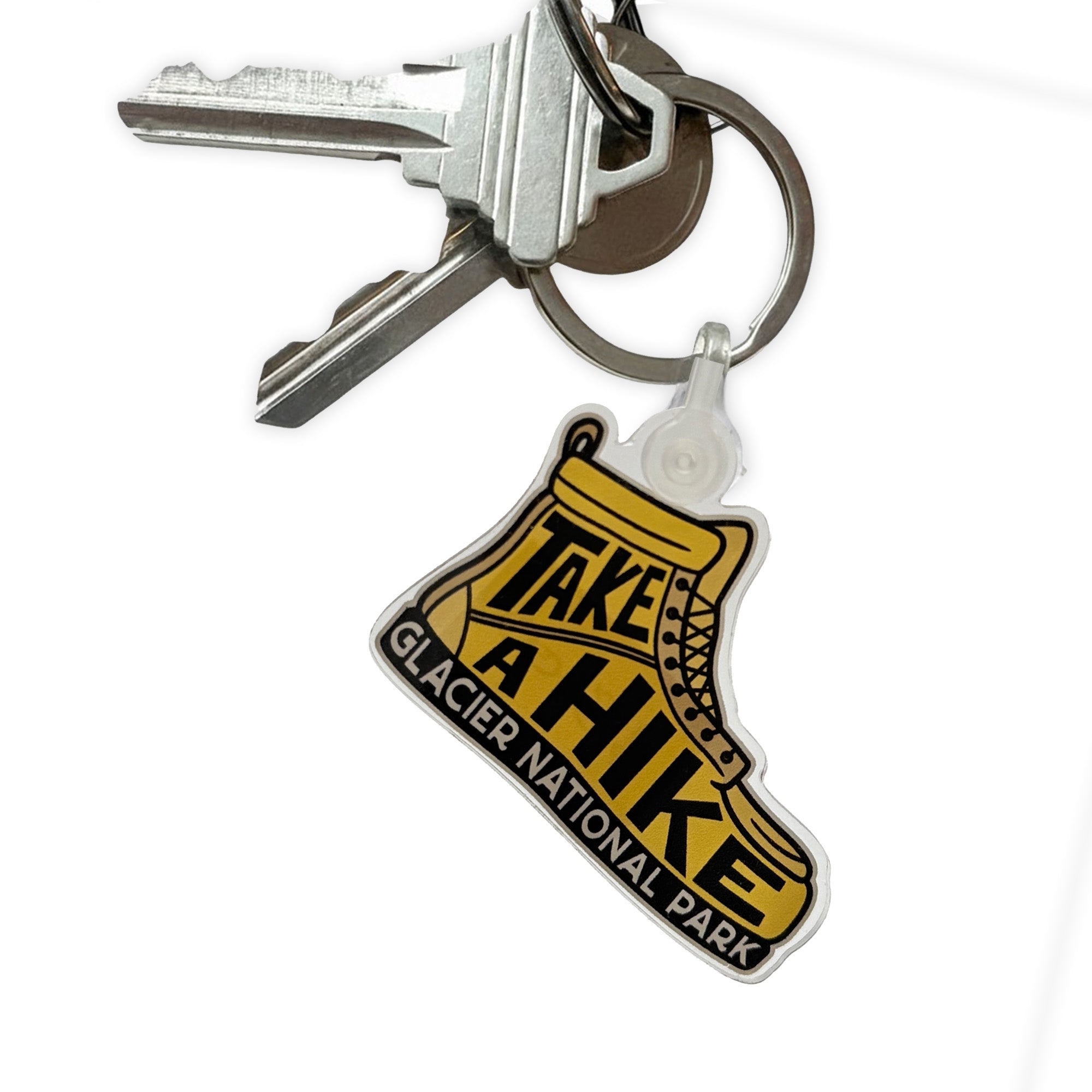 Keychain with 'Take a Hike Glacier National Park' design on a white background