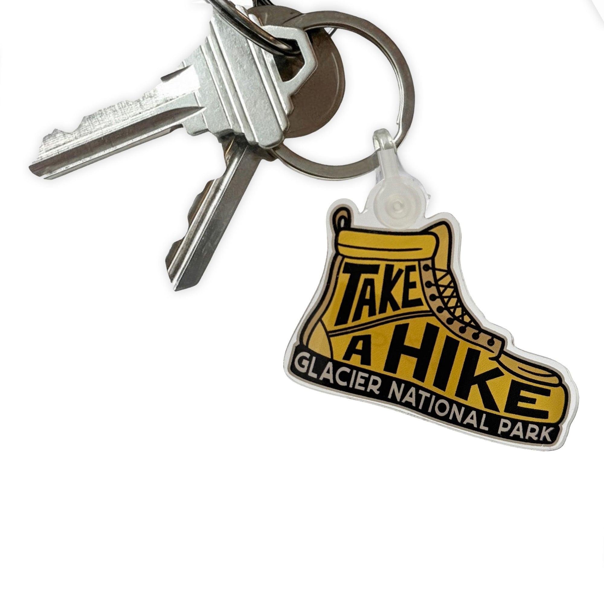 Keychain with 'Take a Hike Glacier National Park' design on a white background