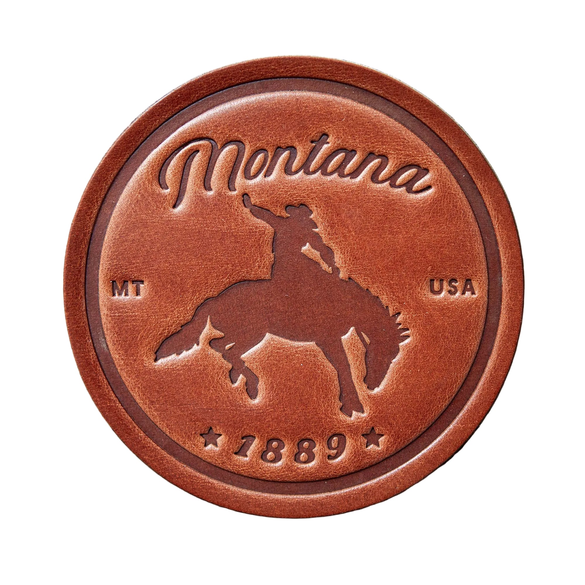 Brown leather medallion with 'Montana' and horse design on a wooden background