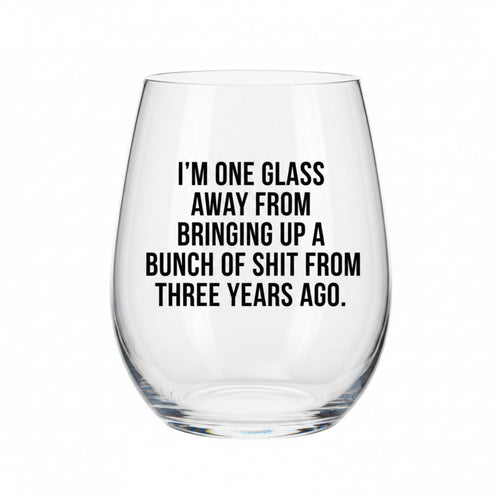 Clear wine glass with humorous text on a white background