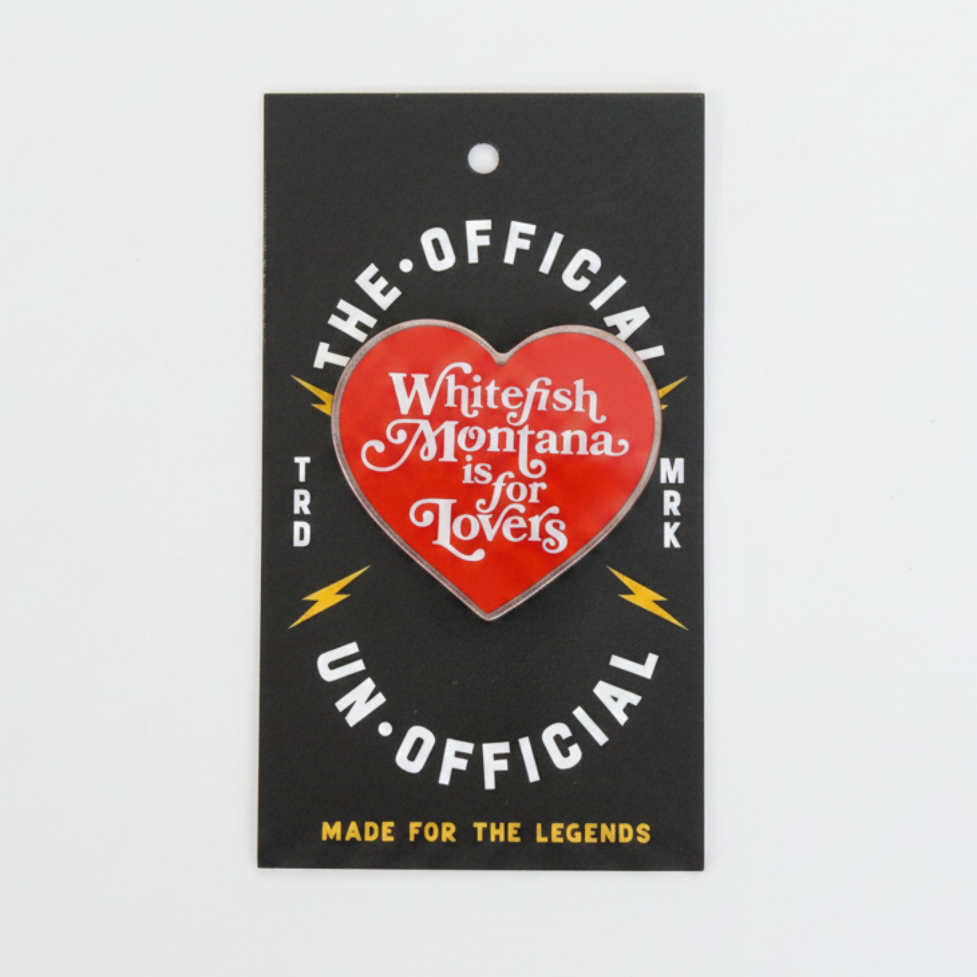 Heart-shaped badge with text on a black card against a light gray background