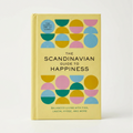 Book titled 'The Scandinavian Guide to Happiness' with colorful geometric design on a light background