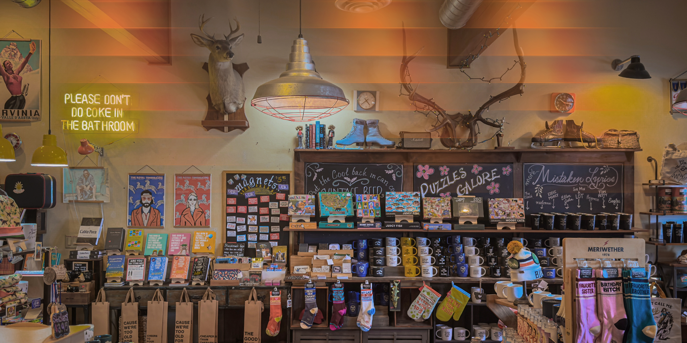 Store interior with shelves stocked with products, posters on the wall, and decorative elements.