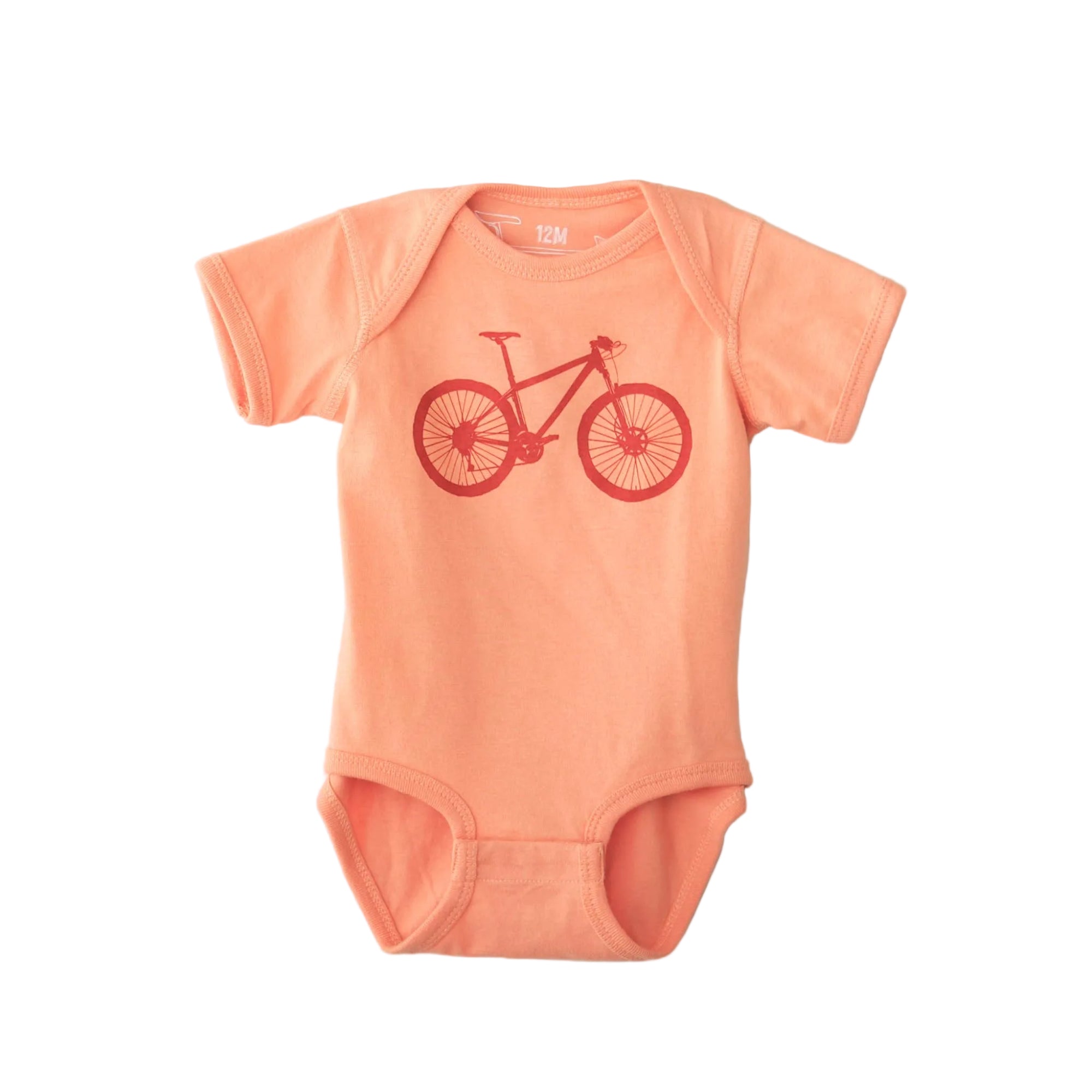 Peach-colored baby onesie with a red bicycle design on a light gray background