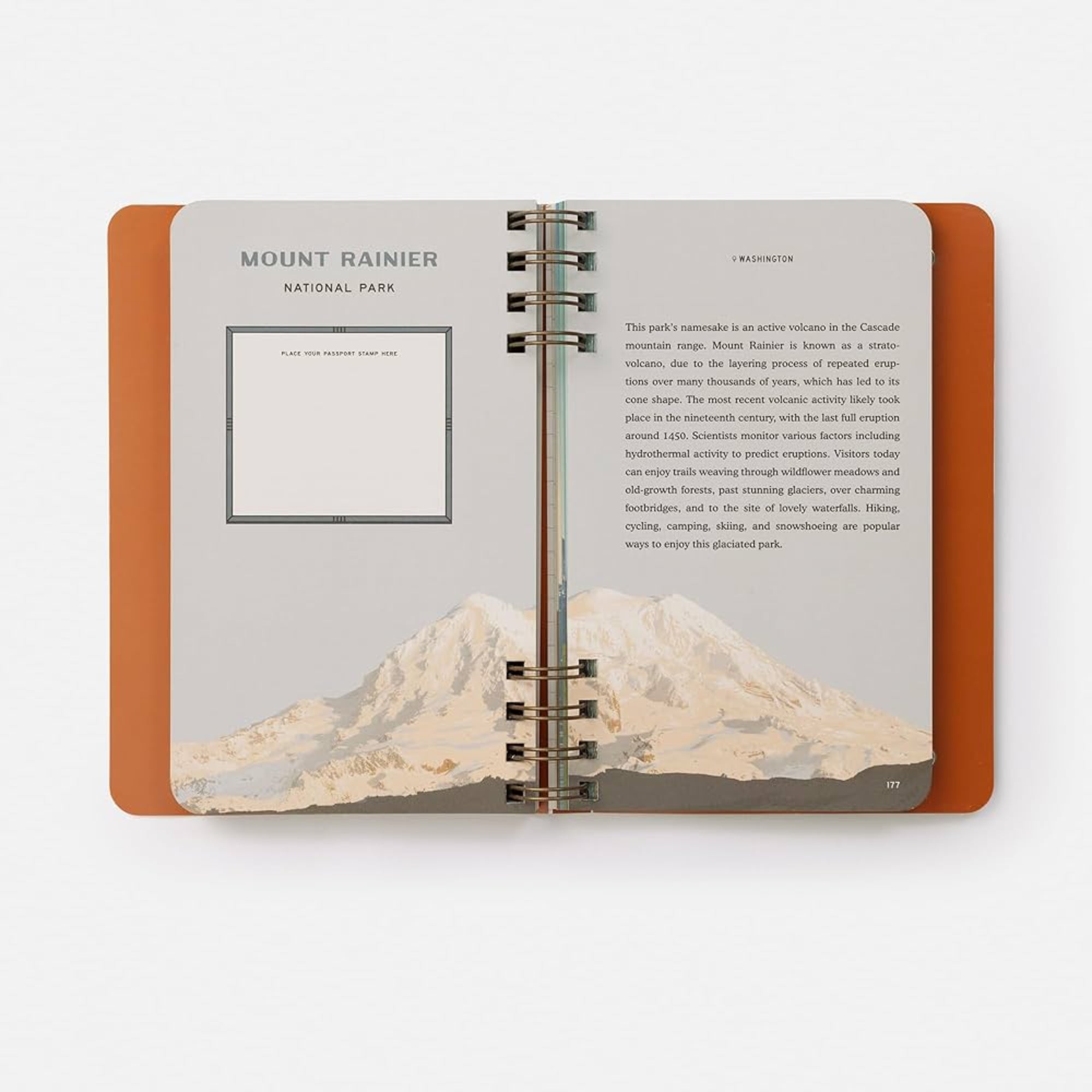 Open notebook with Mount Rainier illustration and text on a white background