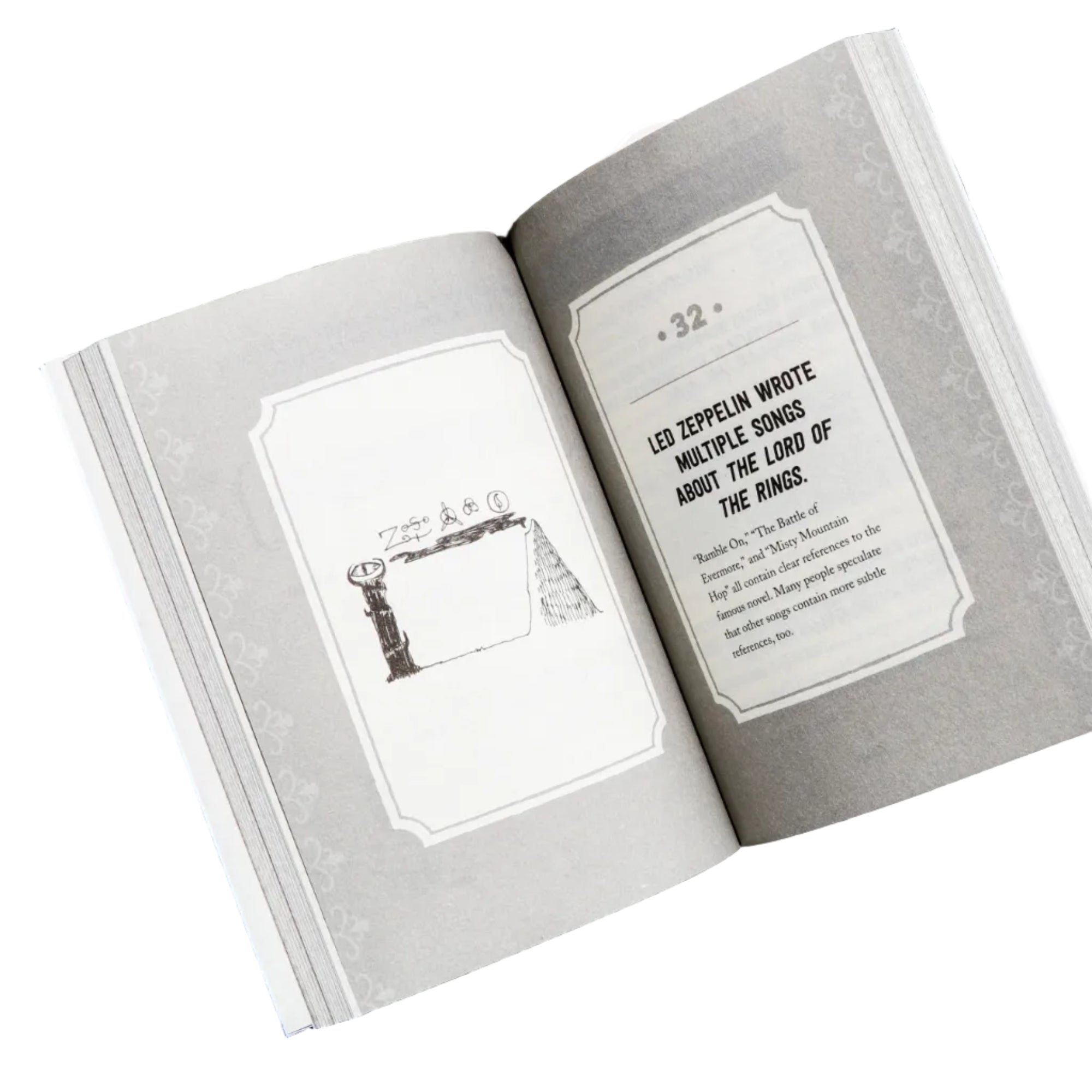 Open book with illustrations on a white tray against a dark background
