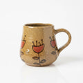 Ceramic mug with artistic designs on a white background