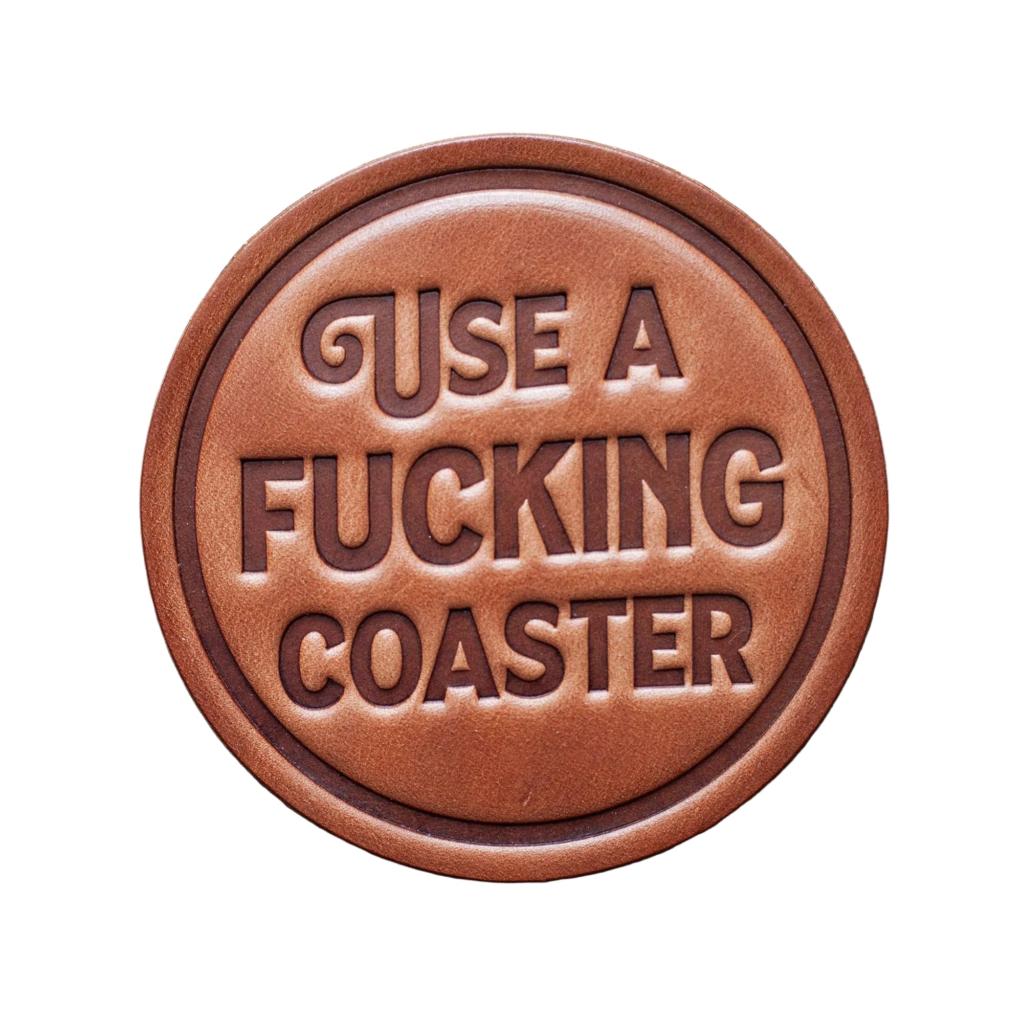 Round brown leather patch with embossed text on a wooden background