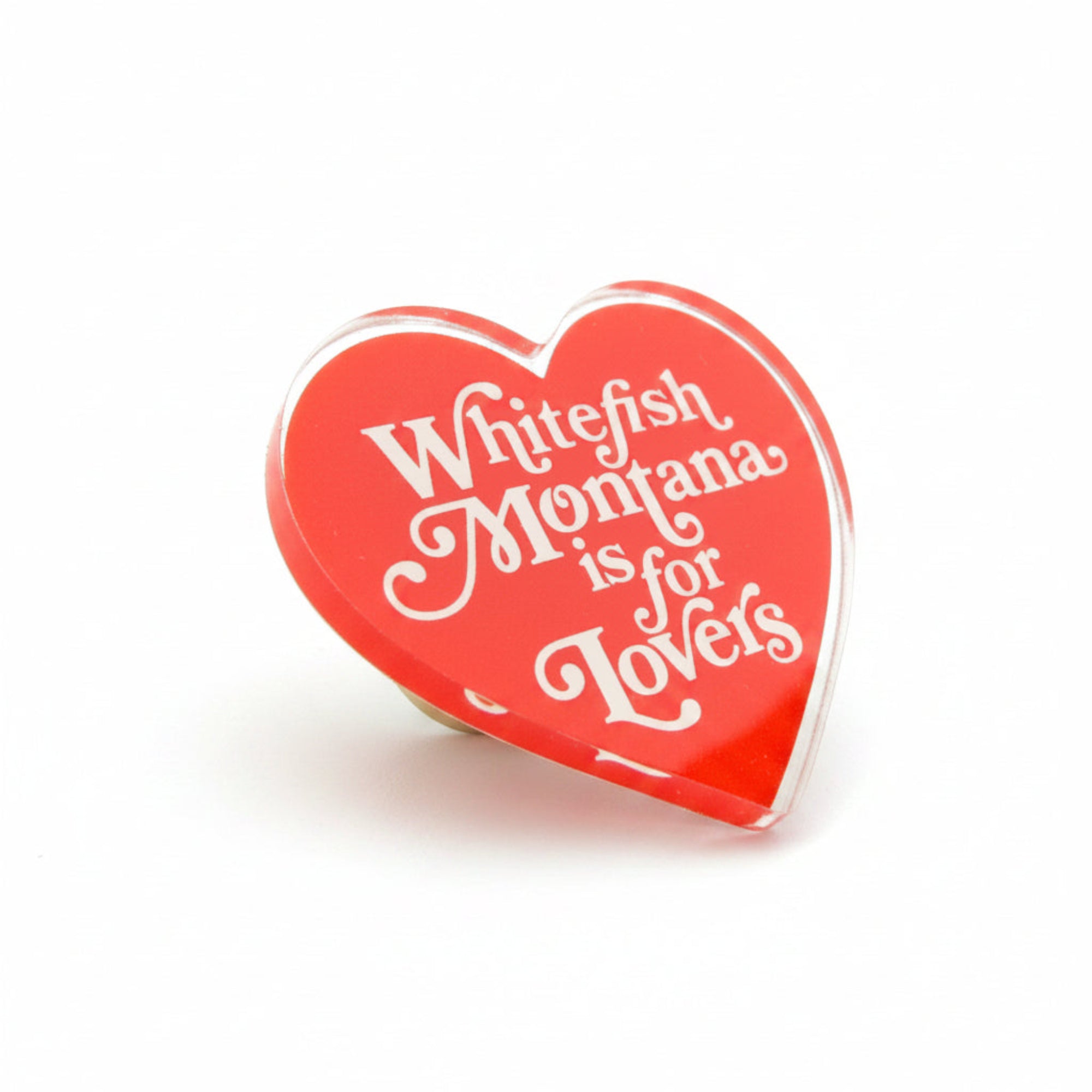 Red heart-shaped button with 'Whitefish Montana is for Lovers' text on a white background.
