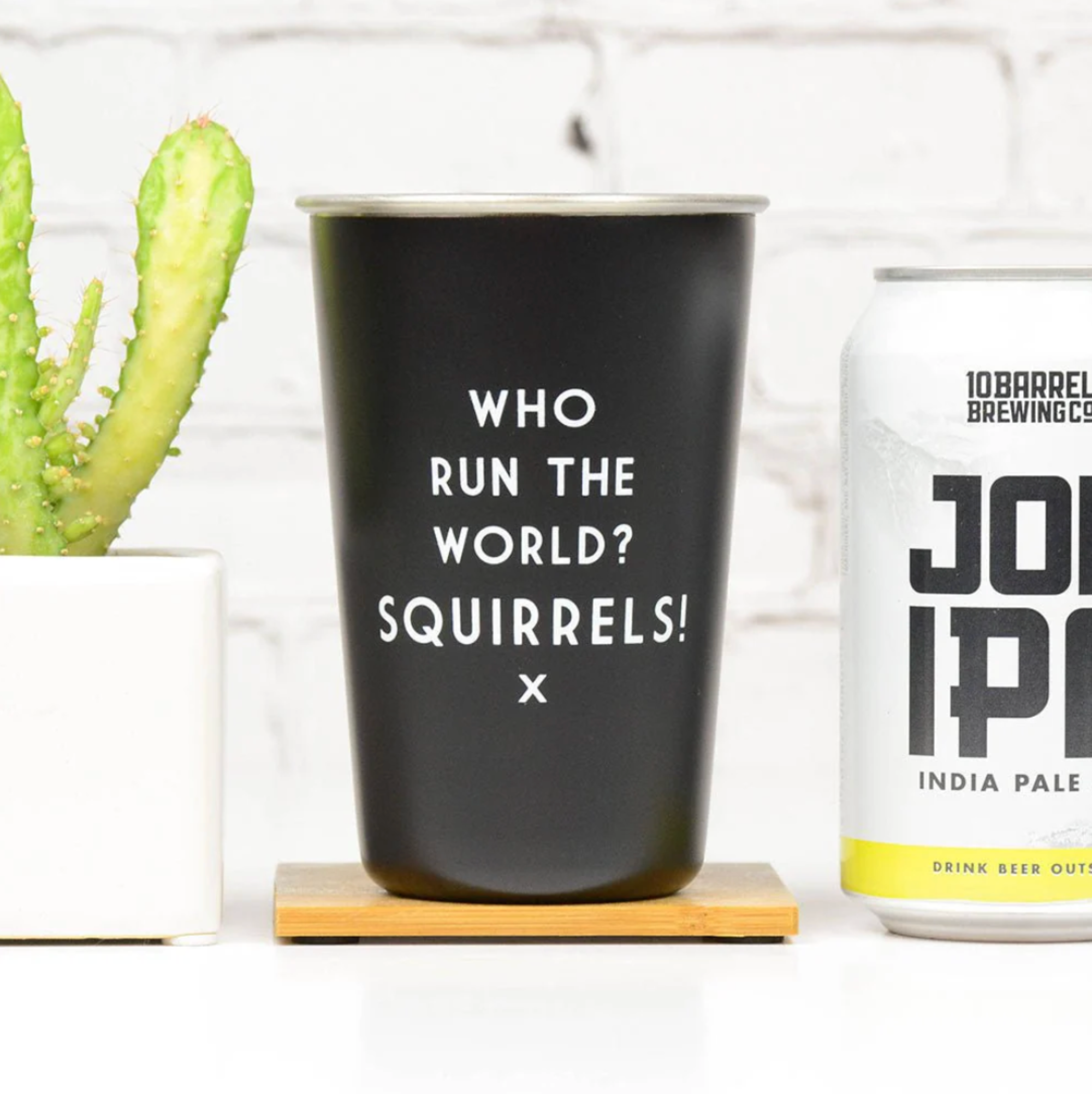 Black cup with 'Who Run the World? Squirrels!'