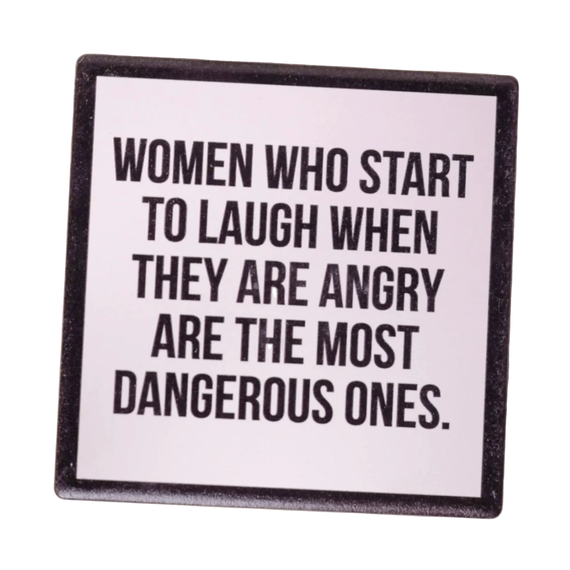 Ceramic Coaster with text 'Women who start to laugh when they are angry are the most dangerous ones' on a wooden surface.