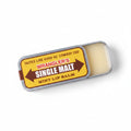 Wrangler's Single Malt mint lip balm on a blue patterned background