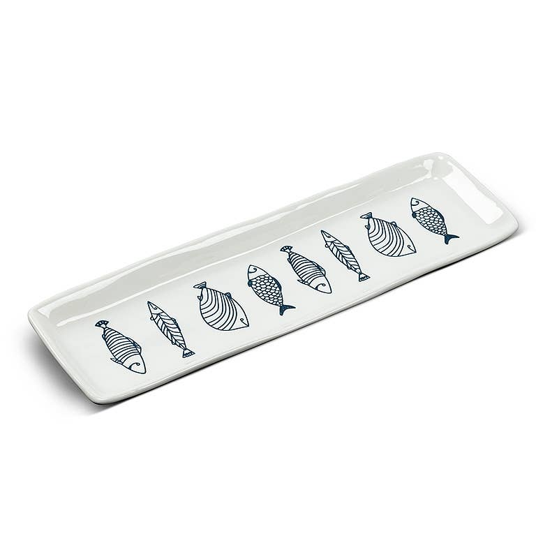 Long white stoneware serving plate with blue line-drawn fish, from The Ruddy Duck in Whitefish, Montana