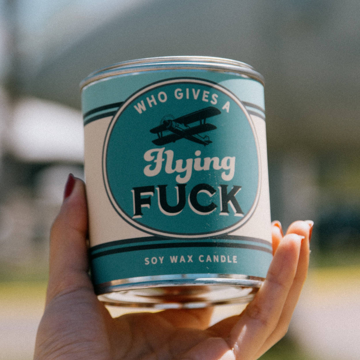 Who Gives a Flying Fuck vintage paint can candle with blackberry, amber, and sweet tobacco notes, by Whiskey River Soap Co., from The Ruddy Duck in Whitefish, Montana