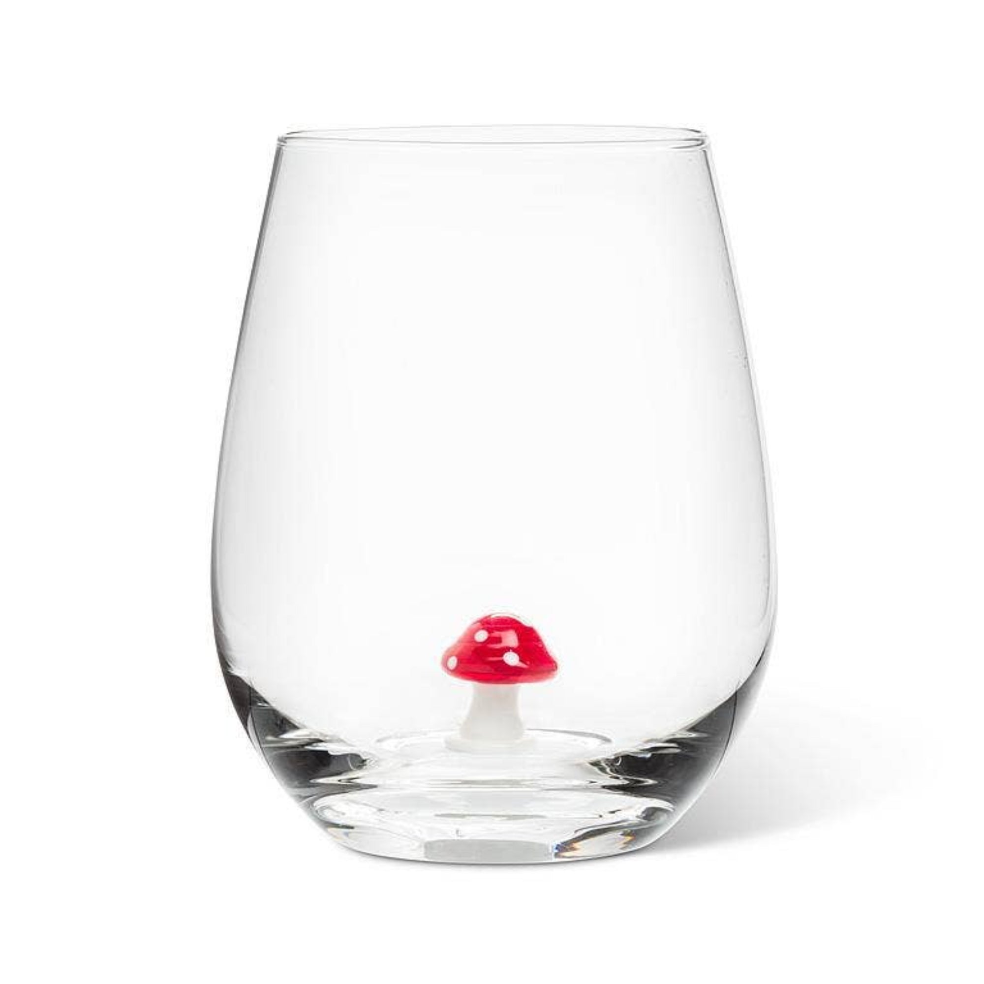 Clear glass with a red mushroom charm on a white background